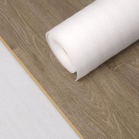 Valge parketi alusvaip rullis, paksus 3 mm, laiusega 1,2 m ja nähtava pikkusega. Taustal helepruun puidumustriga põrand.