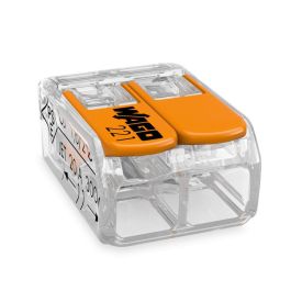 Läbipaistev plastikust elektriline klemm kahe oranži kraaniga, mille küljel on märgistused ja avanemisavad juhtmete sisestamiseks.